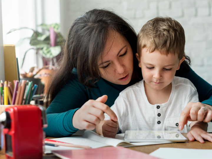 Mum And Young Boy Looking At A Piece Of Paper