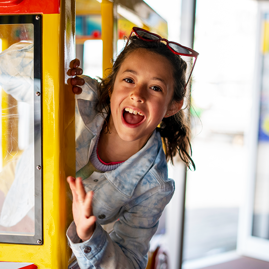 Excited girl in supermarket ride.