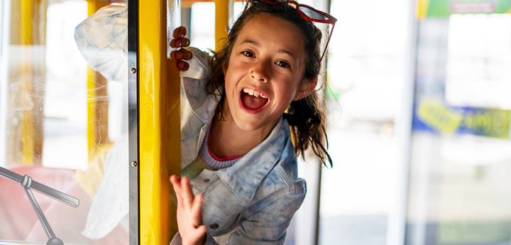 Excited girl in supermarket ride.