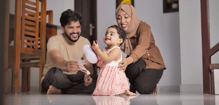 Happy Indian Muslim Family with little Daughter at Home