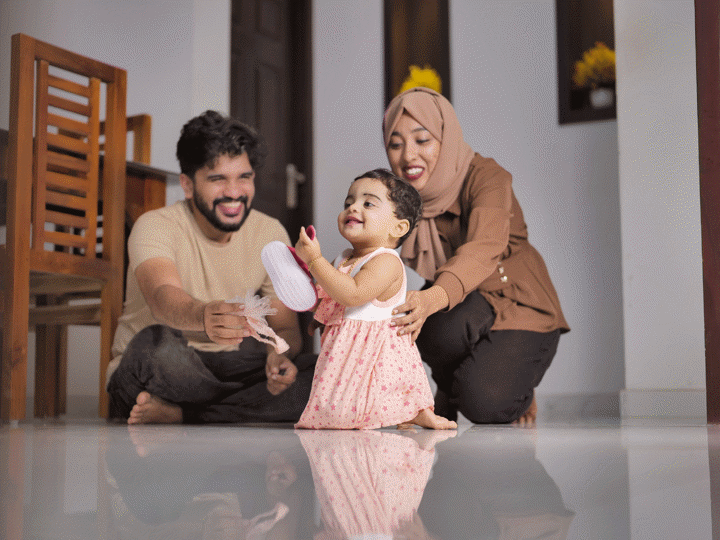 Happy Indian Muslim Family with little Daughter at Home