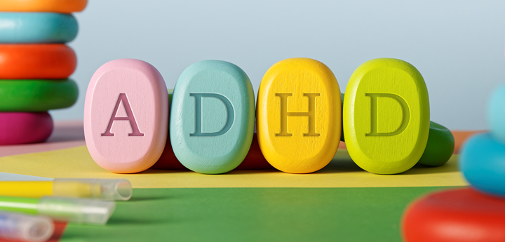 4 colourful pills with the letters A, D, H and D printed on each of them.