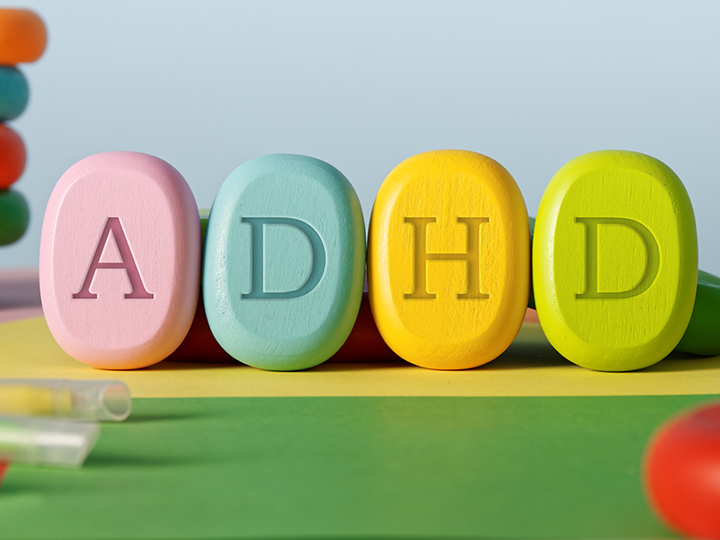 4 colourful pills with the letters A, D, H and D printed on each of them.