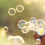 Young child blowing bubbles outdoors