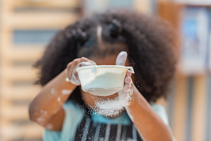 girl sifting flour