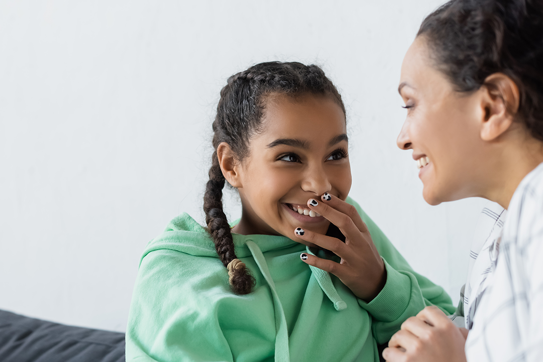 Girl Smiling And Talking With Adult