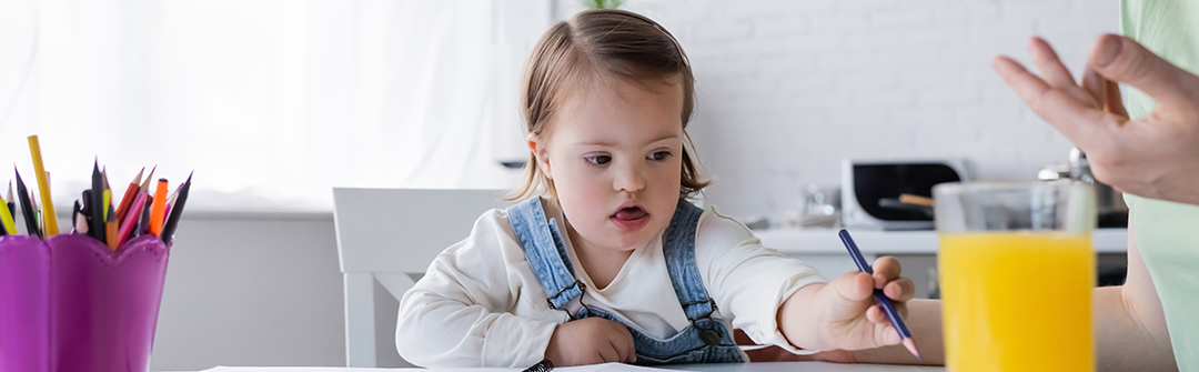 A child with down syndrome drawing.