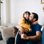 Loving Father Embracing Daughter While Sitting On Sofa At Home 1