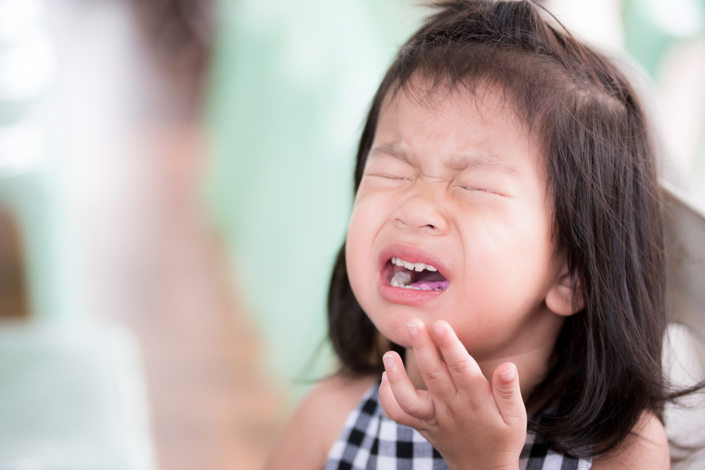 Toddler crying with her eyes shut