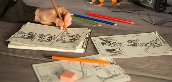 A child drawing comic characters at a table